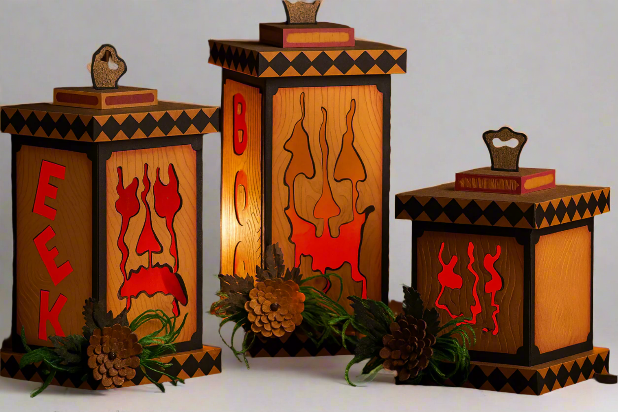 Wooden lanterns with Halloween designs and text, glowing warmly in a dark setting.