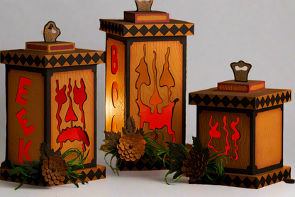 Wooden lanterns with Halloween designs and text, glowing warmly in a dark setting.